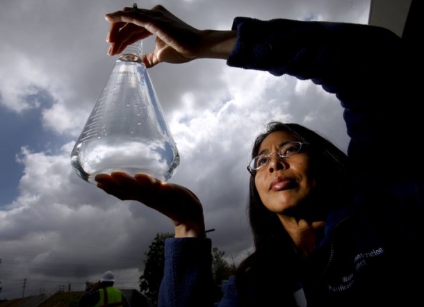 Amy Dorman, senior civil engineer with the city of San Diego's Public Utilities Department holds a sample of water purified to the quality level of pure distilled water at the Advanced Water Purification Facility in University City at the North City Water Reclamation Plant. — Howard Lipin